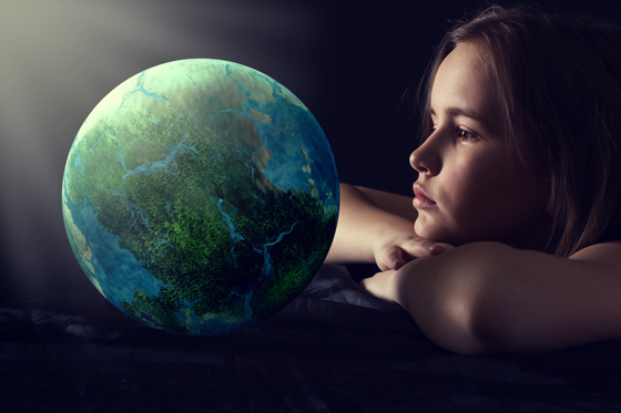 elearning provider in UK and Worldwide young girl staring inquisitively at a depiction of the world